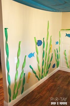 an empty room with fish painted on the wall