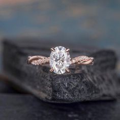 a close up of a diamond ring on a rock