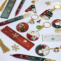 various christmas themed items are arranged on a white surface with gold trimmings and snowflakes