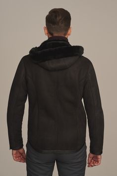 Short men's black sheepskin jacket made of delicate, natural lambskin. It has a stand-up collar and zippers at pockets and sleeves. Fastened with a zipper slightly shifted to the side. Men's sheepskin jacket with a detachable hood with a sporty character designed for people who do not like hats. Type of material: 100 % shearling Length: 73 cm Fastening: Zipper Care tips: Special cleaning of leather products Model's height: Our model is 186 cm tall and wears size 52 You can find other models of sheepskin coats at: https://andrzejkonopka.pl/main-eng.html Ask for a product: sklep@andrzejkonopka.pl Measuring instruction:   You should measure oneself and compare your measurements with table of sizes in order to set the perfect size, which is necessary for order. You should stay in straight posi Shearling Aviator Jacket, Aviator Jacket, Coat With Hood, Sheepskin Jacket, Aviator Jackets, Leather Products, Shearling Coat, Detachable Hood, Care Tips