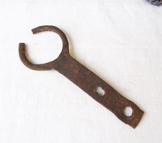 an old rusty wrench sitting on top of a white towel with holes in it