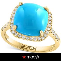 a large blue stone surrounded by diamonds in a yellow gold ring with the words efl on it