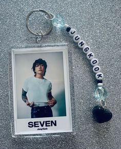 a keychain with an image of a person on it and a name tag attached to it