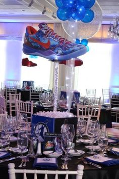 there is a table set up for a party with balloons and shoes on top of it