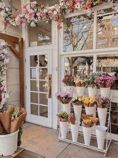 a flower shop with lots of flowers on display