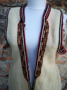 This is a a long vest, also known as 'klashenik' and also as 'resacka' part of the women's ethnic costume from the south western part of Macedonia, Struski Drimkol. This vest was made in the second half of XIX century and is really rare piece of the ethnic costume from this region. The vest has a few damages visible on the photos, a hole at the back side, few damages on the embroidery on the sleeves and a discoloring from washing on some places and that's the reason the price is much lower than Handmade Folk Style Vest For Festivals, Handmade Folk Vest For Festivals, Traditional Sleeveless Vest Outerwear, Traditional Ceremonial Sleeveless Vest, Traditional Fitted Vest For Fall, Traditional Sleeveless Winter Vest, Traditional Fitted Fall Vest, Embroidered Photo, Vintage Vest