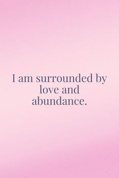 a pink background with the words i am surrounded by love and abundance