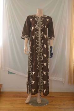 Vintage 60's/70's maxi kaftan dress with floral embroidery, side vents, bell sleeves and buttons all the way down the front. Material seems like a cotton blend. Excellent condition.  W:20" S:21" L:58" Fitted Long Abaya For Spring, Fitted Abaya For Spring, Embroidered Fitted Maxi-length Abaya, Embroidered Fitted Maxi Length Abaya, Fitted Embroidered Maxi-length Abaya, Fitted Embroidered Maxi Abaya, Embroidered Fitted Long Thobe, Embroidered Fitted Thobe, Fitted Embroidered Long Thobe