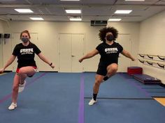 two women in black shirts are doing exercises