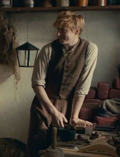 a man standing in front of a wooden table