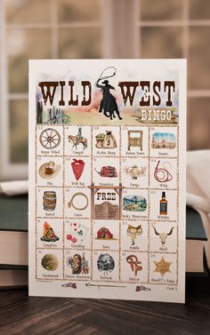 the wild west bingo game sits on top of a book