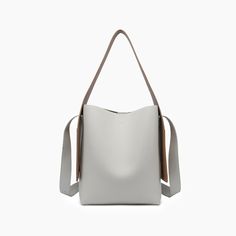 The Desert Dreamer Vegan Tote Bag has understated elegance and versatile design, making it a go-to accessory for the urban nomad. Add a touch of sophistication to any outfit and carry your dreams wherever you go. 100% Vegan Leather 12"W * 13"H * 7"D 6" top handle drop 22" detachable chain link Pull magnetic closure 16.50 oz Style# U2CN07 Desert Dreamer, Vegan Tote Bag, Big Tote Bags, Bow Bag, Designer Crossbody, Designer Crossbody Bags, Understated Elegance, Designer Backpacks, The Urban