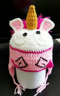 a crocheted unicorn hat on top of a cup