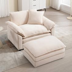 a white chair and ottoman in a room