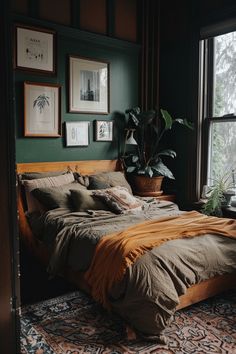 a large bed sitting in a bedroom next to a window with pictures on the wall