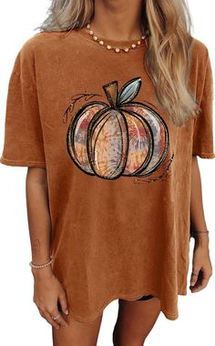 🎃 **Oversized Pumpkin Vibes 🎃   Get cozy in this **Pumpkin Graphic Tee perfect for Halloween and Thanksgiving 🍂. Whether you're sipping cider by the fire 🔥 or prepping for a spooky night out 👻, this oversized fit will keep you comfy and stylish!   ✨ **Why You'll Love It   - Soft, breathable fabric for all-day comfort 😍   - Cute pumpkin design 🎃 for the ultimate fall mood   - Perfect for layering on chilly autumn days 🍁   Add a dash of pumpkin spice to your wardrobe! 🎃👕 Cute Oversized Fall Tops, Cute Oversized Tops For Fall, Spooky Short Sleeve Tops For Fall, Brown Graphic Tee For Fall, Cute Orange Fall Tops, Cute Orange Tops For Fall, Cute Orange Top For Fall, Cute Orange Fall Top, Oversized Brown T-shirt For Fall