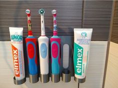 "An awesome way to keep your OralB toothbrushes and two toothpaste tubes organized and clean. It holds the Oral B electric toothbrush shown and any other brush 27.4mm(roughly 1\") or smaller, and toothpaste tubes with a flip head 35mm or smaller. available in many colors and with either screws or adhesive to mount." Electric Toothbrush Storage, Ocarina Instrument, Toothbrush And Toothpaste, Board Game Organization, Toothpaste Squeezer, Game Organization, Toothbrush Storage, Light Moisturizer