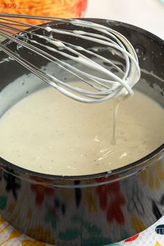 a whisk in a pot filled with batter