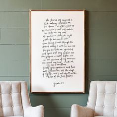 two chairs are in front of a framed poem