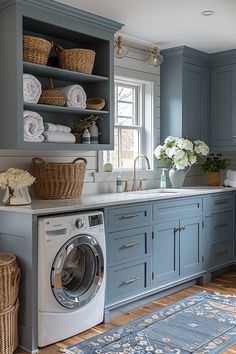 a washer and dryer in a room with blue cabinets