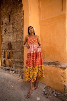 Say hi to Avaani, the epitome of colour blocking from our Secret Garden collection. This full-length, sleeveless dress, made from luxurious cotton, offers both comfort and style. With two side pockets, a waist belt for a perfect fit, and a tiered design with lining, it embodies grace and sophistication while being fun. The delightful combination of bhoota prints and vibrant blooming florals evokes a sense of romance and the carefree spirit of summer. Our favourite dress for wedding guests! This dress comes in two colour variations. The models are 5'9" and wears size S. 100% Organic cotton Waist belt detail Fitted bodice Sleeveless Side pockets Lined Hand-block printed Sundress Women, Summer Dress Floral, Printed Summer Dresses, Colour Blocking, Floral Color, Women Maxi, Floral Dress Summer, Colour Block, Dress Floral