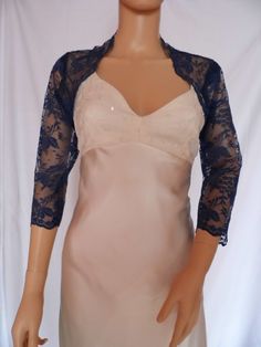 This is a beautiful, delicate, hand made dark blue lace shrug ideal for weddings or special occasions. It can be worn to dress up casual clothes as well. The lace edging provides an attractive edge to the shrug and its sleeves. It can be made in any size from 8 to 24 (UK sizes). It is made in the UK. (For larger sizes please see my separate listing). It is normally sent out to you within 5 days, but I am very happy to make your order a priority if you need it urgently. Just let me know the date Elegant Fitted Lace For Wedding Night, Fitted Lace For Mother Of The Bride, Fitted Scalloped Lace For Wedding Night, Fitted Blue Lace Top With Lace Trim, Fitted Lace Top For Wedding Night, Elegant Blue Lace Top, Elegant Blue Lace Top With Lace Trim, Fitted Lace Shrug With Lace Trim, Fitted 3/4 Sleeve Party Shrug