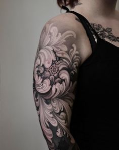 a woman with tattoos on her arm and shoulder