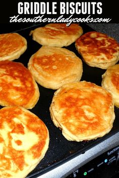 some biscuits are cooking in a pan on top of the stove and there is text overlay that reads griddle biscuits