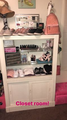 a closet with shoes and purses on it, next to a pink carpeted floor