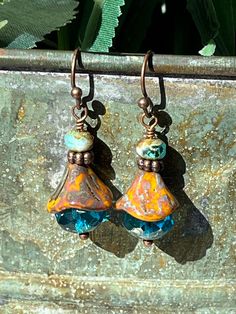 "Perfect dainty earrings to help us think of Spring flowers!!  These beautiful lightweight drop earrings are made with large blue fire-polished Czech glass topped with more light brown Czech glass in the shape of a flower with more copper and a small Czech bead.  A fun combination that you can wear with anything and sparkle!!  I love Czech glass - each bead is like a piece of artwork to me, so I have a lot of fun creating with them! **Each piece of Daisy Light Jewelry is delivered packaged in a brown kraft box with a double organza bow and charm.  If you have two or more boxes, I will note what is in each box for easy gift giving. **If you want Christmas color organza ribbon and Christmas charm, please make a note to me at checkout (silver, white, red, and/or green) **My \"professional pho Blue Teardrop Bohemian Flower Earrings, Blue Bohemian Teardrop Flower Earrings, Bohemian Blue Teardrop Flower Earrings, Blue Dangle Earrings With Bead Caps, Bohemian Blue Flower Earrings With Dangling Beads, Blue Bead Cap Drop Earrings, Blue Teardrop Flower Earrings With Ear Wire, Unique Blue Flower Earrings With Ear Wire, Blue Picasso