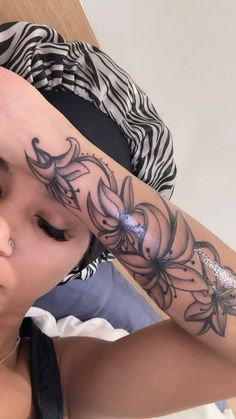 a woman with a tattoo on her arm