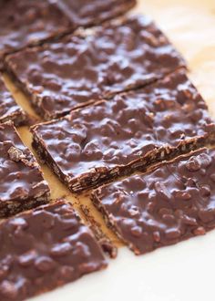 chocolate brownies are cut into squares on a cutting board, ready to be eaten