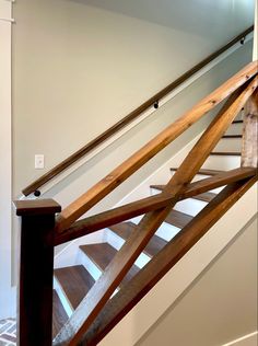 a stair case with wooden handrails in a home