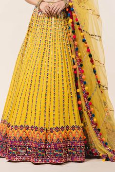 Yellow lehenga with attached cancan, all-over multicolored applique work, sequin embellishments and drawstring with tassels. Comes with sweetheart neckline padded blouse and tulle dupatta.
Component: 3
Embroidered
Neckline: Sweetheart
Sleeve Length: Sleeveless
Fabric: Lehenga and Blouse: Georgette; Dupatta: Tulle 
Color: Yellow
Applique, resham, sequin and patra embroidery
Embroidered blouse with cutwork and pompoms at the hem
Tie-up at the back with pompoms
Embroidered dupatta - Aza Fashions Bohemian Saree-style Wedding Gown, Festival Party Anarkali Set With Cutdana, Yellow Floor-length Dupatta For Reception, Bohemian Wedding Dress With Motifs, Semi-stitched Yellow Choli With Motifs, Multicolor Resham Embroidery Palazzo Set For Wedding, Yellow Palazzo Set With Dupatta For Reception, Bohemian Traditional Wear For Festive Wedding, Yellow Wedding Gown For Festivals