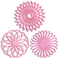 three pieces of pink plastic art that look like flowers