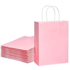 pink paper bags stacked on top of each other