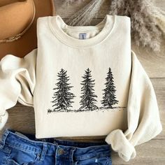 Embrace your wild side with this Pine Tree Sweatshirt, perfect for nature lovers and adventurous souls. Whether you're camping, hiking, or just channeling your inner granola girl, this cozy sweater makes the perfect gift for anyone who loves the great outdoors! Prefer this design on a T-Shirt? Visit this link:  Everything You Need to Know: 🧥 Sweatshirt Brand Gildan | Unisex Adult Sizing | 50% Cotton, 50% Polyester ⏳🚚 Production & Shipping All items are made-to-order. They will ship within 1-5 business days from one of our printing partners, shipping usually takes between 2-5 business days after the item is shipped. Please allow sufficient time for production and shipping.  Important: Please double-check your shipping address before checking out. A fee will apply if an order needs to be r White Cotton Sweater For Outdoor, Cozy Cotton Sweatshirt For Outdoor Activities, Outdoor Cotton Crew Neck Sweater, Outdoor Long Sleeve Cotton Tops, Relaxed Fit Long Sleeve Tops For Adventure, White T-shirt For Outdoor Winter Activities, Cotton Graphic Print Sweatshirt For Adventure, Casual Cotton Sweatshirt For Adventure, White Long Sleeve Adventure T-shirt