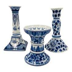 three blue and white vases sitting next to each other