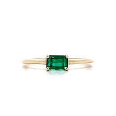 Emerald Stacking Ring in 14k Yellow Gold This modern solitaire and stacking ring features an eye-catching .56 carat emerald cut emerald set in 14 karat yellow gold. The emerald cut emerald reflects a dazzling green hue. This solitaire design has the stone set east/west, allowing the ring to be stacked with others. PRIMARY STONE Stone: Emerald Shape: Emerald Weight: .56 ct Measurements: 5.52 mm x 3.72 mm x 3.22 mm CHARACTERISTICS Ring Size: 7.0 Resizable: Yes Height Above Finger: 4.90 mm Measurem Emerald Cut Green Stackable Rings In 14k Gold, 14k Gold Emerald-cut Stackable Rings For May Birthstone, 14k Gold Stackable Emerald-cut Rings For May Birthstone, Classic Green Emerald Cut Stackable Rings, Classic Green Emerald Stackable Rings, Classic Green Emerald-cut Stackable Rings, Green Emerald Cut Solitaire Birthstone Ring, Green Solitaire Birthstone Ring With Emerald Cut, 14k Gold Emerald Cut Solitaire Birthstone Ring