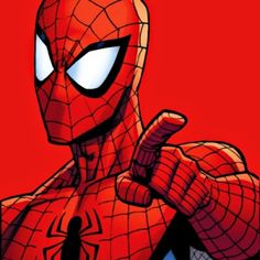 the spider - man is pointing at something with one hand and his other thumb up