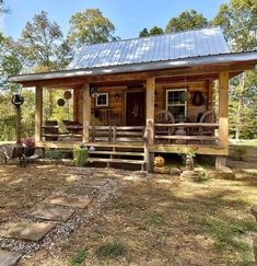 a small log cabin sits in the woods