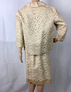 "No tags, possibly handmade Beautiful ivory/beige lace over satin jacket and skirt set is perfect for a wedding or vow renewal Measurements are approximate and taken laying flat, double where appropriate Skirt 13.5\" waist (27\" doubled) 19\" hips (38\" doubled 26\" length Jacket 19\" chest armpit to armpit 19\" waist 17\" sleeve length 23\" length center back collar to hem The snap is missing for the bow, see pictures and the loop for the hook at the collar could be tightened Small spot on righ Fitted Cream Lace Sets, Cream Lace Fitted Sets, Formal Fitted Lace Sets, Elegant Beige Wedding Sets, Elegant Formal Sets With Lace Trim, Spring Wedding Lace Sets, Elegant Lace Sets With Lace Trim, Fitted Lace Trim Set For Wedding, Wedding Lace Sets With Lace Trim