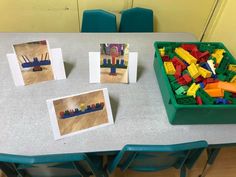 legos are sitting on the table with cards and pictures in front of them,