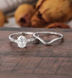 a diamond ring sitting on top of a wooden table