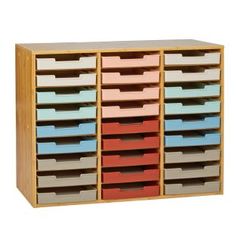 multicolored drawers are stacked on top of each other in this wooden storage unit