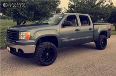 a gray truck parked on the side of a road