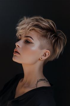 Edgy short hair with shaved sides is a bold and stylish choice for those looking to make a statement with their hairstyle. Side Shaved Hairstyles Short, Feminine Undercut, Faux Hawk Women, Short Hair Shaved Sides, Pixie Cut Shaved Sides, Textured Fringe, Undercut Women, Choppy Layers