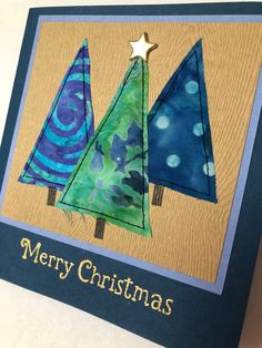 a card with three christmas trees on it