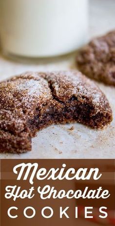 mexican hot chocolate cookies with powdered sugar on top and in the background, there is a glass of milk