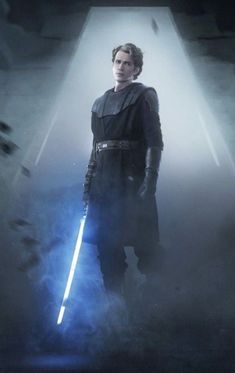 a man standing in the dark with a light saber on his hand and lights coming from behind him